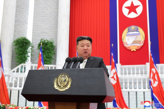 This photo, carried by North Korea's official Korean Central News Agency on Tuesday, shows the North's leader Kim Jong-un giving a speech in a meeting with senior party and government officials on the occasion of the 76th founding anniversary of the regime. (Yonhap)