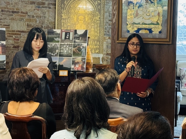 Aditi Kumar (right), a 17-year-old high school student from India, shares her experience with exhibition attendees at the 