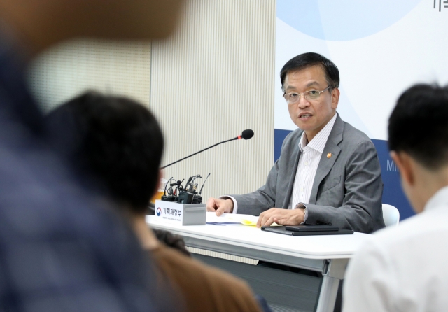 Finance Minister Choi Sang-mok speaks during a meeting with reporters at the government complex in the central city of Sejong on Monday, in this photo provided by his office. (Yonhap)