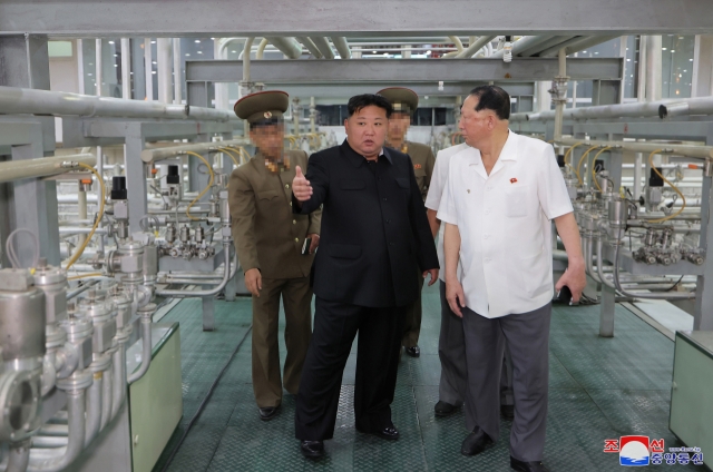 North Korean leader Kim Jong-un (center) visits the Nuclear Weapons Institute and the production base of weapons-grade nuclear materials, in this image provided by the North's official Korean Central News Agency on Friday. (Yonhap)