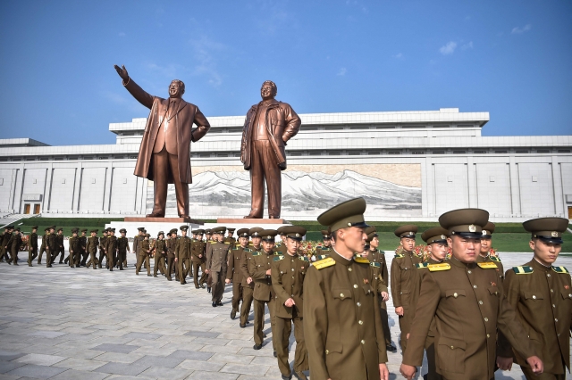 Service personnel of the Ministry of Public Security pay tribute as they visit the statues of late North Korean leaders Kim Il-sung and Kim Jong-il at Mansu Hill in Pyongyang on September 9, 2024, on the occasion of the 76th founding anniversary of North Korea. (AFP)