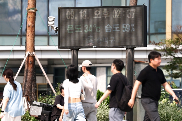 An electronic display board in Songpa-gu, southern Seoul, reads temperature levels at 34 degrees Celsius and humidity levels at 59 percent, as a heat wave warning was issued across most parts of the city on Wednesday. (Yonhap)